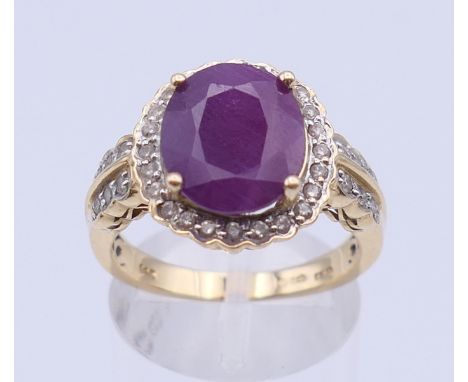 A 14 ct gold, ruby and diamond cluster ring. Ring size P/Q. 5.6 grammes total weight.