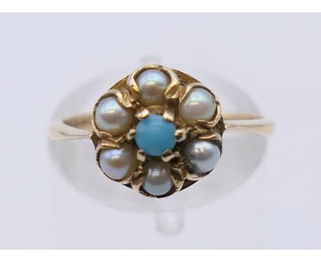 A 9 ct gold seed pearl and turquoise ring. Ring size M. 2.3 grammes total weight.