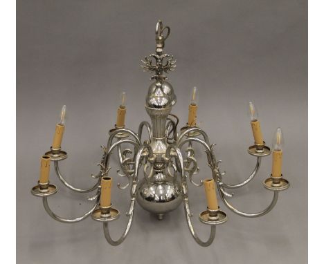 An eight-branch silvered brass chandelier. 62 cm high.