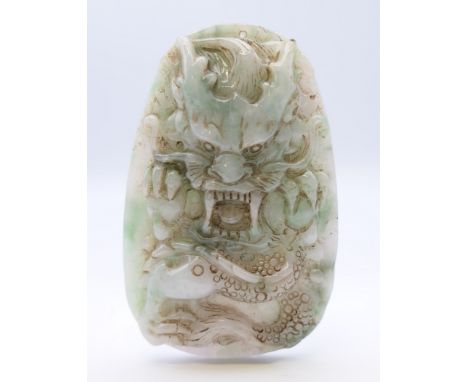A Chinese light green and white jade dragon pendant, Qing Dynasty. 8 cm high.Provenance: The Larkin/Minney Collection. 