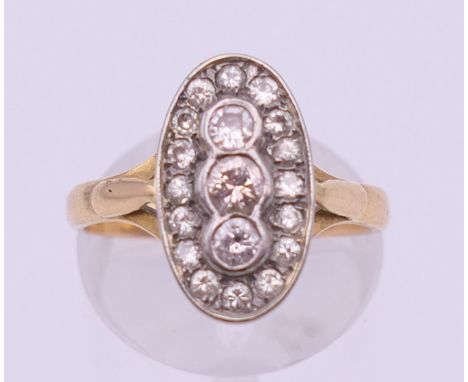 An 18 ct gold diamond set oval cluster ring. Ring size N. 4.3 grammes total weight.