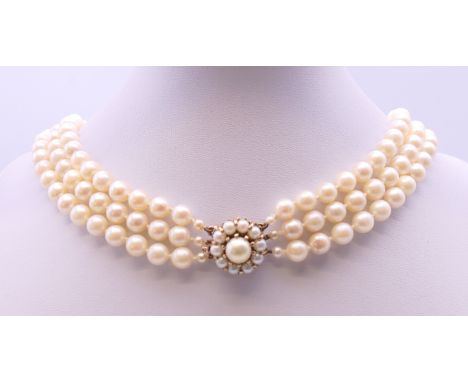 A three strand pearl necklace with a 9 ct gold clasp.  41 cm long. 