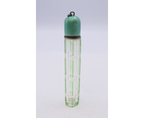 A green overlay glass scent bottle with enamel lid. 8 cm high. 