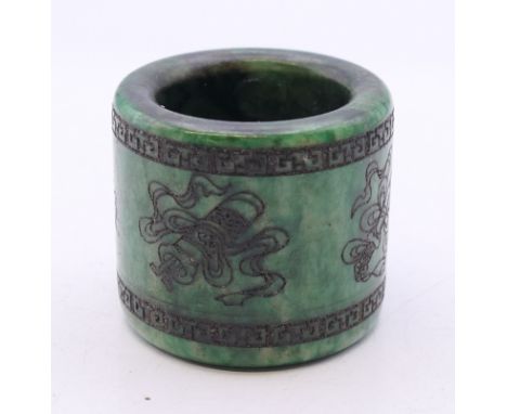 An engraved jade archer's ring.  3 cm high. 