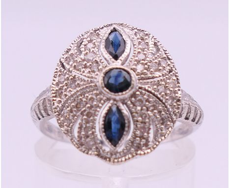 A 14 ct white gold, diamond and sapphire cluster ring. Ring size M/N. 3 grammes total weight.