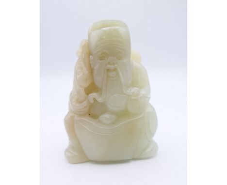 A Chinese light green jade carved figure of an old man, Qing Dynasty. 5.5 cm high.Provenance: The Larkin/Minney Collection. 