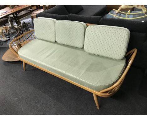 An Ercol pale elm day bed