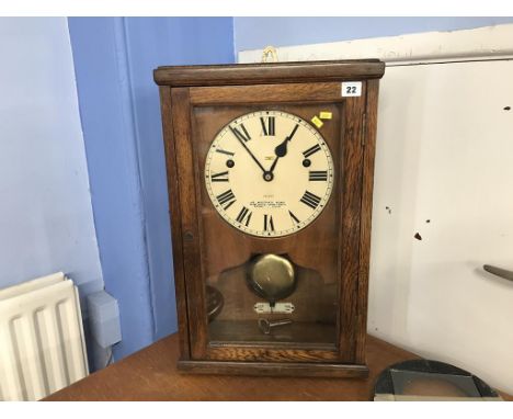 An oak cased 8 day wall clock, 'North East Time Recorder Limited'
