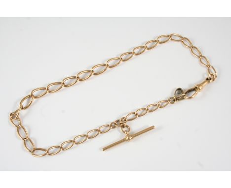 A 15CT. GOLD WATCH CHAIN formed with oval-shaped links, suspending a gold 't' bar, 33cm. long, 23.1 grams.