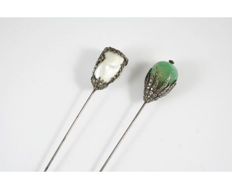 A FRENCH BELLE EPOQUE EMERALD AND DIAMOND HAT PIN mounted with a large emerald in a diamond set foliate mount, together with 