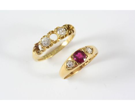 A RUBY AND DIAMOND THREE STONE RING the oval-shaped ruby is set with two old-cut diamonds, in 18ct. gold, size N, together wi