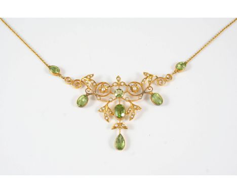 AN EDWARDIAN PERIDOT AND SEED PEARL NECKLACE the gold openwork foliate design is set overall with oval-shaped peridots and se