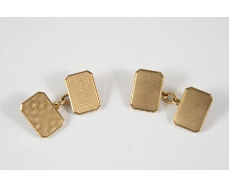 A PAIR OF 9CT. GOLD CUFFLINKS of rectangular-shape with cut corners and engine turned decoration to each link, 13.2 grams.