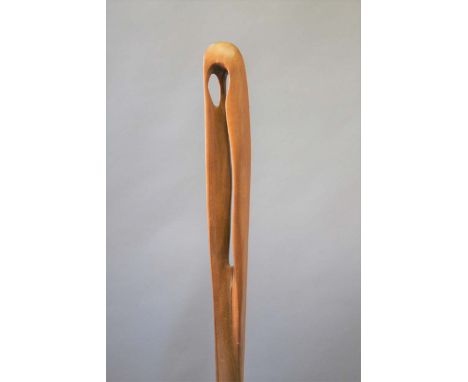 WOODEN SCULPTURE a large slender wooden sculpture made in teak, supported on 3 metal prongs and a wooden plinth. Marked on th