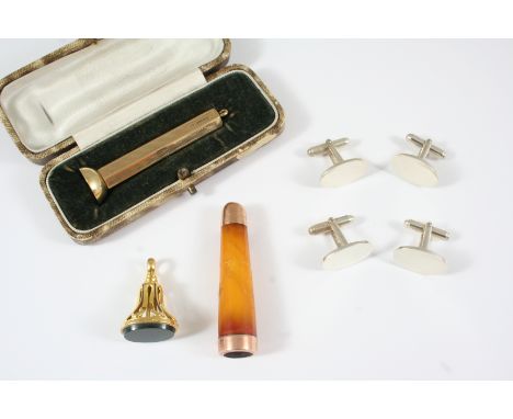 A 9CT. GOLD CIGAR PIERCER with engine turned decoration, 6cm. long, 12.8 grams, with case, an 18ct. gold and bloodstone seal,