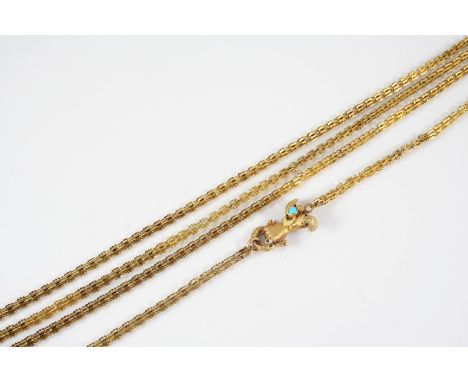 A VICTORIAN GOLD LONG GUARD CHAIN the fancy link chain with a gloved hand clasp, mounted with an oval turquoise and a small g