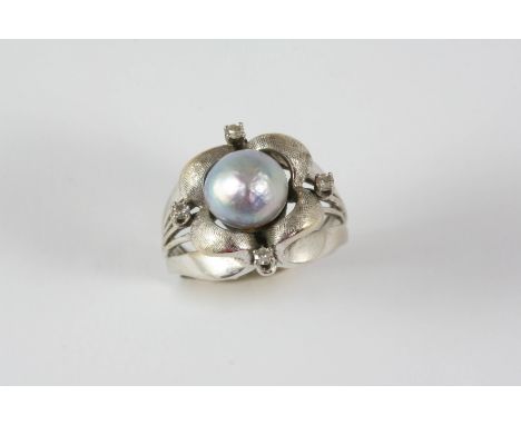 A CULTURED PEARL AND DIAMOND RING the grey cultured pearl is centred within a white gold mount set with four circular-cut dia