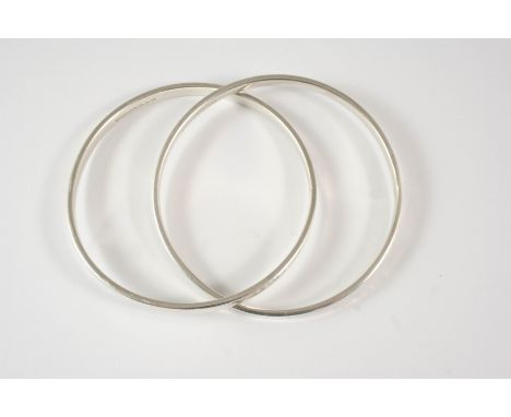 A SILVER DOUBLE BAND BANGLE BY TIFFANY &amp; CO. formed as two interlocking silver bangles, each signed T &amp; CO. With Tiff