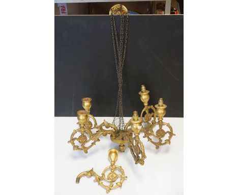 A carved wooded gilt chandelier five branch ceiling light of classical form together with spare arm. 