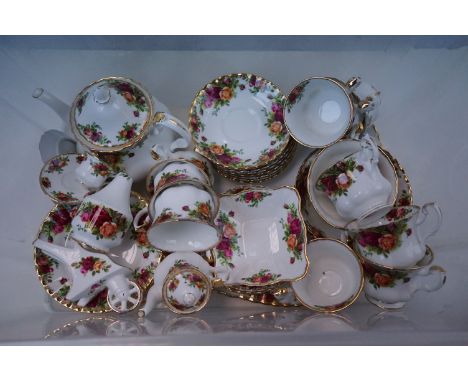 A Royal Albert Country Roses part tea set to include cups and saucers teapot bowl etc. 