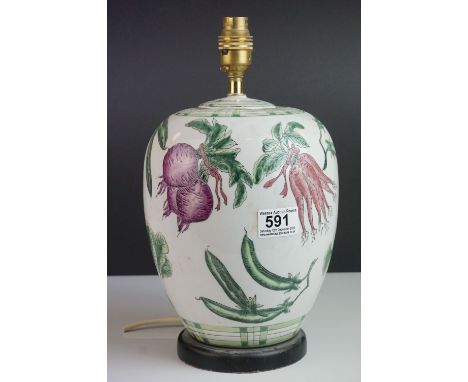 A pottery ovoid lamp decorated with vegetables. 