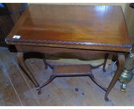 An Edwardian Mahogany Foldover Card Table; of rectangular form with red leather inset on cabriole supports.