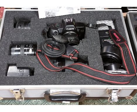 A Canon Camera along with Accessories to Include a Tripod, both cased.