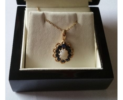 An Opal and Sapphire Pendant on a 9ct Gold Chain.