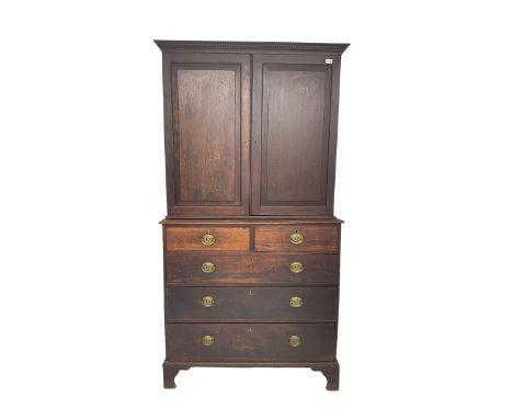 George III oak linen press, projecting cornice with dentil moulding over two panelled doors enclosing two adjustable shelves,