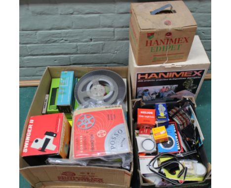 A large selection of camera and film accessories including slide magazines, a Polaroid Swinger II camera, projector spools, H