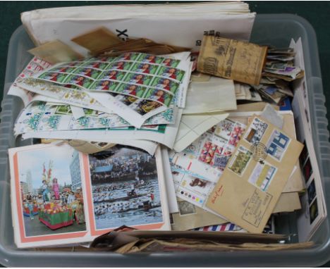 A box of mixed GB and world stamps, mainly loose with some first day covers