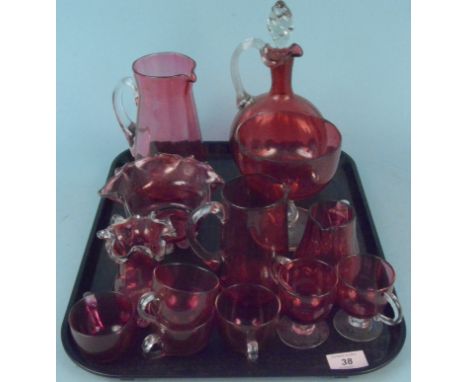 A cranberry glass claret jug, four smaller jugs, two bowls and various custard cups