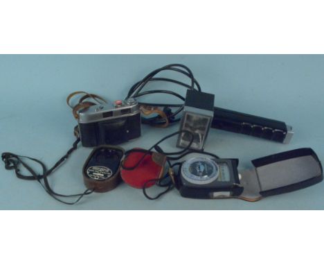 A vintage Kodak Retina II together with two exposure meters and a flash unit