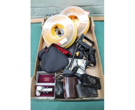 A box of photographic accessories including a vintage Kodak camera