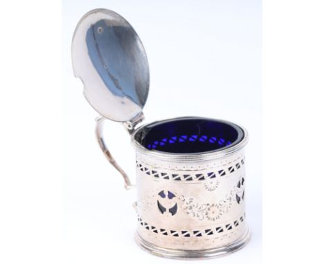 A George III silver mustard pot with blue glass liner, pierced thumb piece, scroll handle and pierced & engraved body, Robert