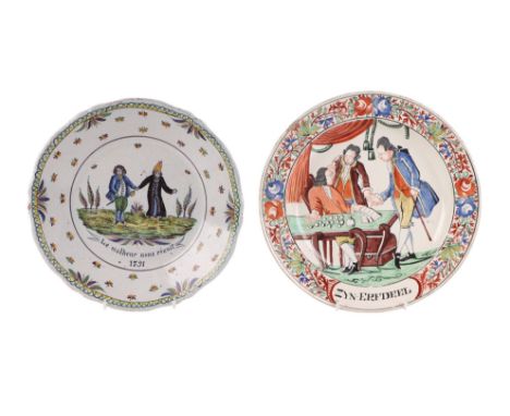 A late 18th century French faience tin glazed earthenware plate decorated with figures and motto 'Le Malheur Nous Reunit' (Mi