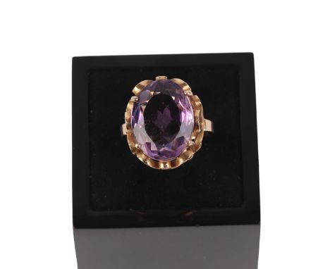 A 14ct gold ring set with a large oval amethyst, approx UK size K, 5.4g.