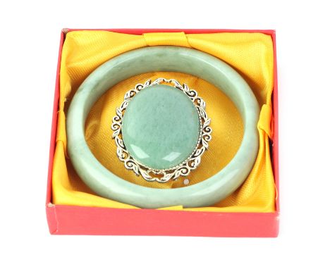 A modern white metal set jade brooch; together with a jade bangle, boxed.
