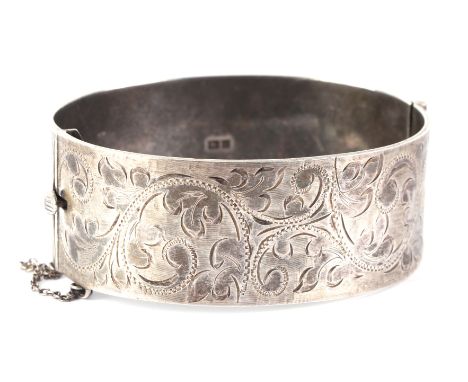 A silver hinged bangle with foliate engraved decoration, 66g.