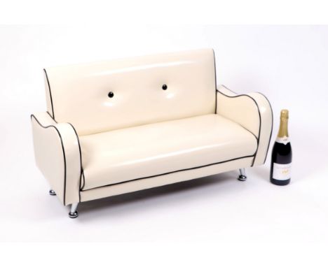 A child's miniature 1950's style SoFine by Fineline vinyl button backed sofa on chrome supports, approx 85 by 42cms, suitable