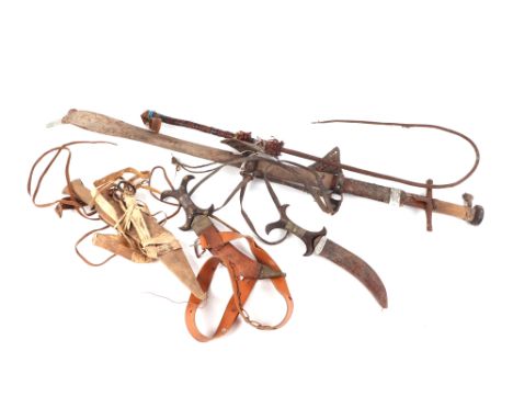 A North African sword and scabbard, together with various ethnic daggers, bull whips and other items.