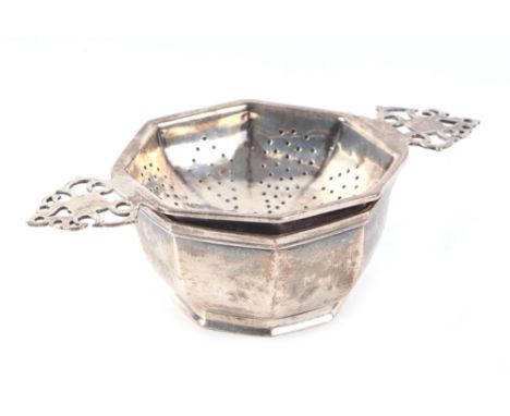 A modern silver tea strainer and stand of octagonal form, London 1959 (2).
