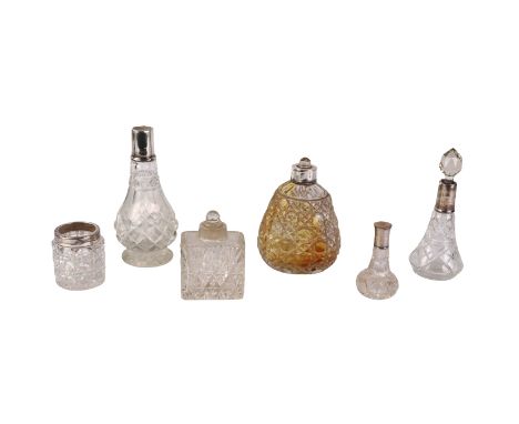 A group of silver mounted cut glass dressing table jars and perfume bottles.