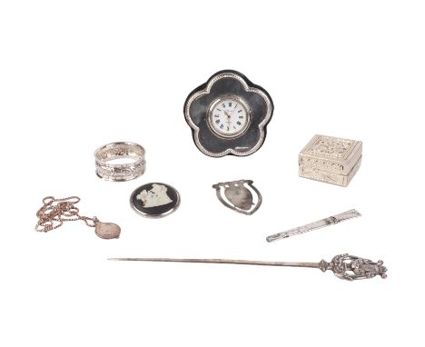 A silver mounted desk clock; together with a silver napkin ring, a silver pendant and necklace and other items.