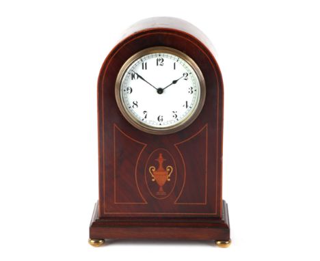 An Edwardian mantle clock in a mahogany dome topped case with inlaid decoration, on bun feet, the 8cm white porcelain dial wi