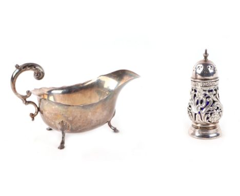 A George V silver sauce boat with scroll handle, Chester 1929; together with an Edwardian silver pepperette, Birmingham 1904,