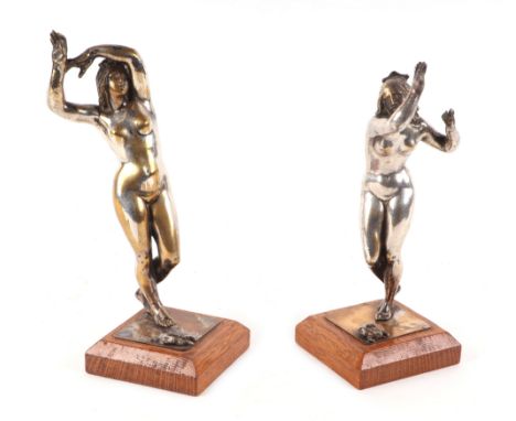 A pair of silver plated cast bronze classical female figures with frogs at their feet, mounted on wooden plinths, each 19cms 