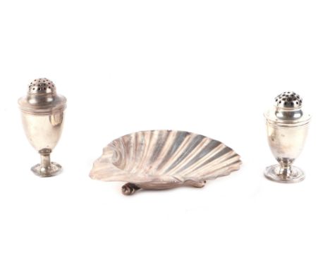A pair of George III silver pepperettes, London 1799, 53g; together with a Victorian silver shell shaped butter dish, marks r