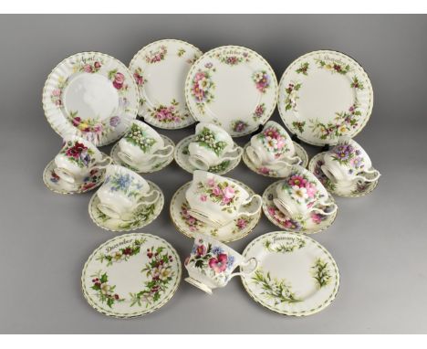 A Collection of Royal Albert Flowers of the Month Series Teawares to Comprise Cups, Saucers, Side Plates and Small Plates