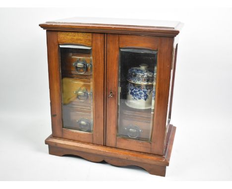 An Edwardian Mahogany Smokers Cabinet with Glazed Panelled Doors to Fitted Interior with Two Short and One Long Drawers, Cera